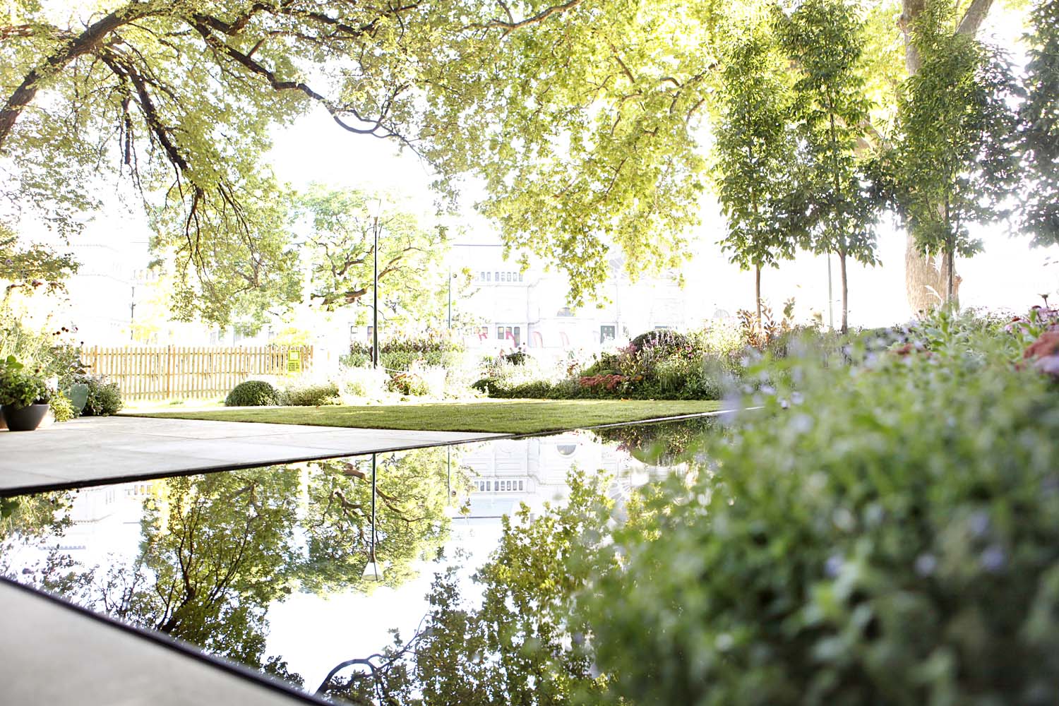 Beautiful trees in the Carlton Gardens reflect onto the surface of the black pool in 'The New Wave' by Ian Barker Gardens at MIFGS 2013