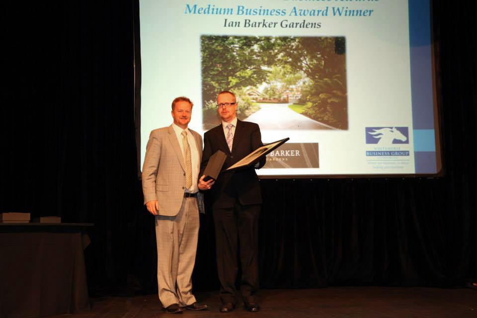 Ian Barker from landscape design company Ian Barker Gardens accepting the Whitehorse Business Group medium business award from David Thompson of Your Child in Whitehorse.
