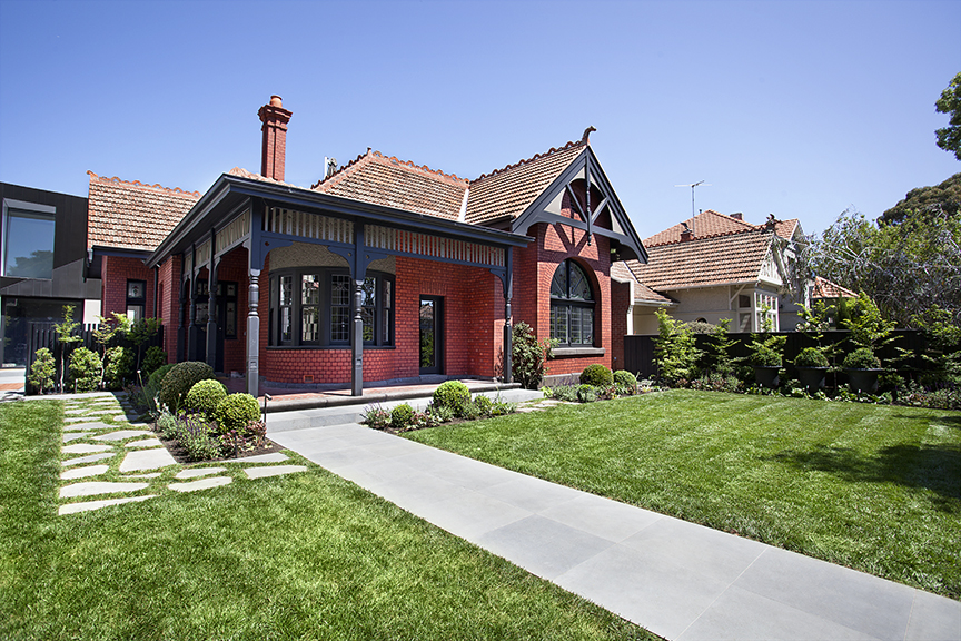 Ian Barker Gardens has designed a traditional front garden with lawn, crazy pavers and perennial planting to perfectly complement the architecture of this heritage property in St Kilda